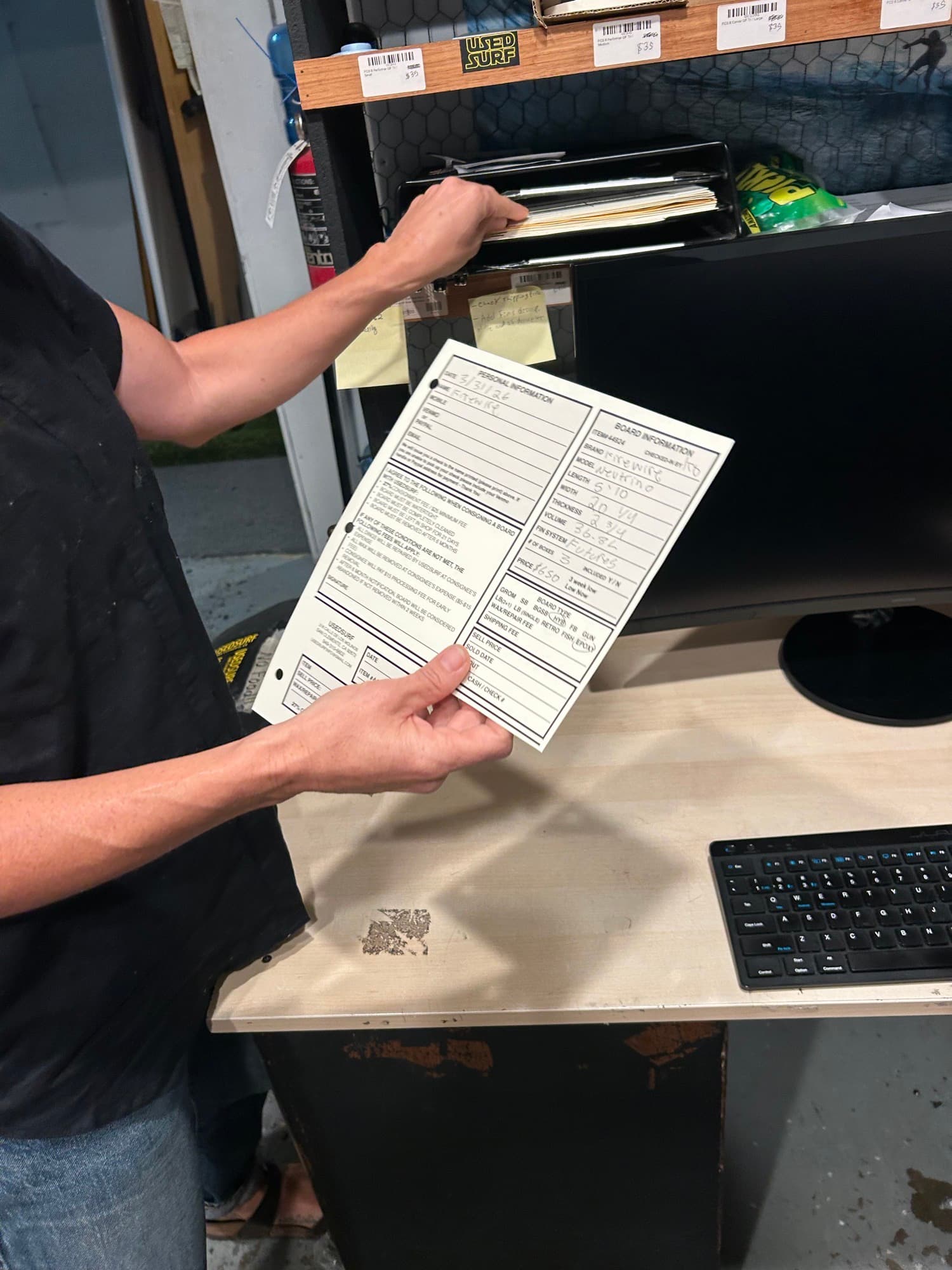 Handwritten USED SURF consignment intake form, filled out by hand before being keyed into the computer